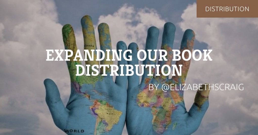 Hands covered in blue paint and maps of the world against the background of the sky.