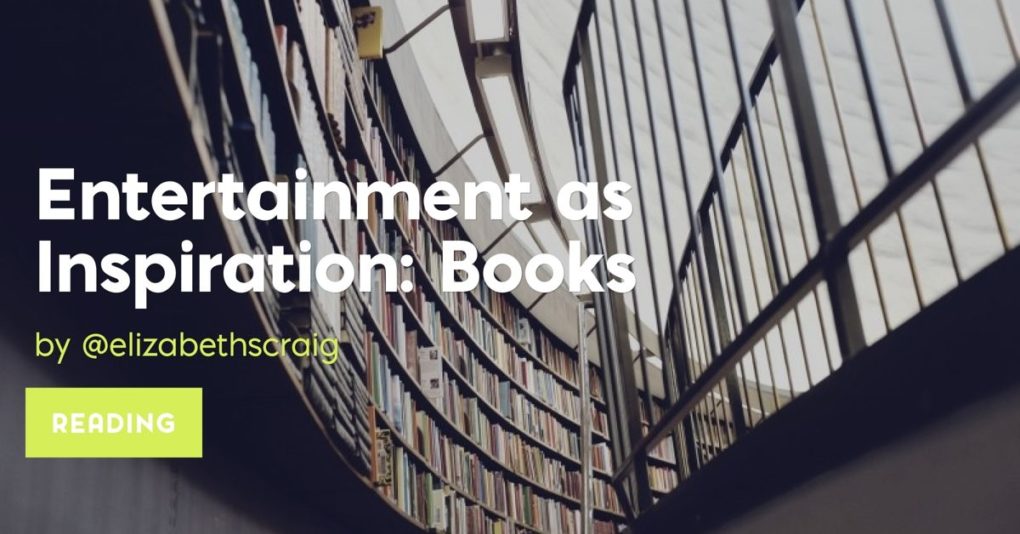 A curving wall of books near a staircase.